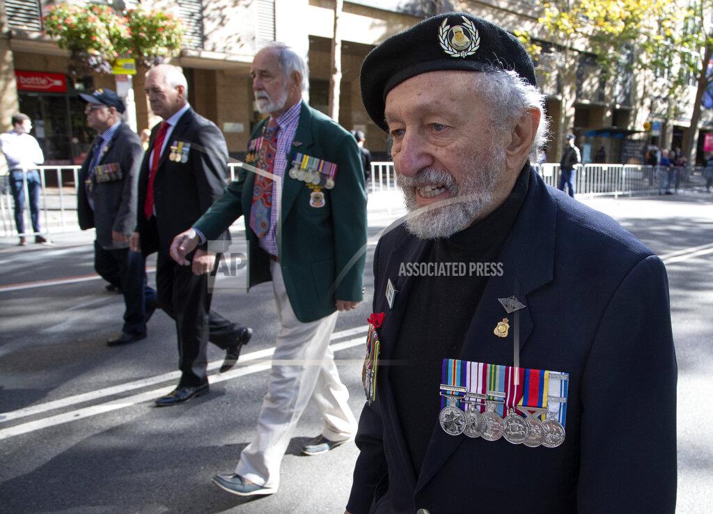 Mark Baker Veterans march during the Anzac Day parade in Sydney, Australia, Sunday, April 25, 2021. Australians and New Zealanders paid tribute to their war dead Sunday as both nations prepared to withdraw from their longest war in Afghanistan. (AP Photo/Mark Baker)