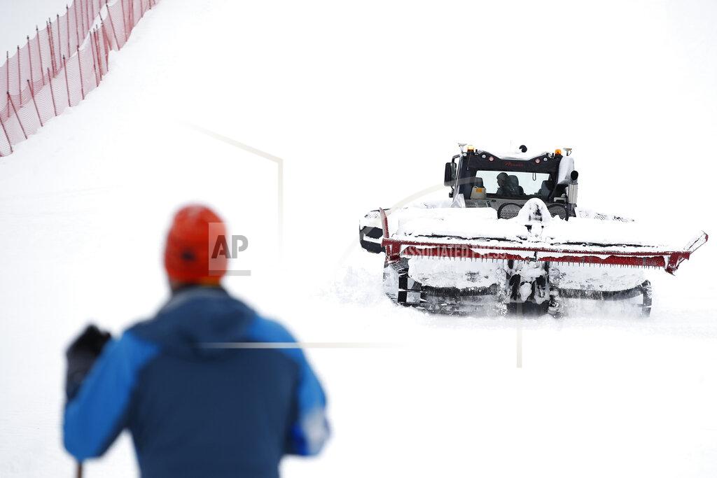 Gabriele Facciotti A snow plough is clearing snow on the course as the alpine ski, men's and women's World Cup downhill were cancelled due to weather conditions, in Lenzerheide, Switzerland, Wednesday, March 17, 2021. (AP Photo/Gabriele Facciotti)