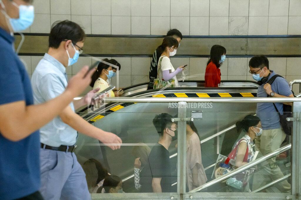 Mark Schiefelbein People wearing face masks to protect against COVID-19 walk through a subway station during the morning rush hour in Beijing, Wednesday, Aug. 4, 2021. The coronavirus’s delta variant is challenging China’s costly strategy of isolating cities, prompting warnings that Chinese leaders who were confident they could keep the virus out of the country need a less disruptive approach. (AP Photo/Mark Schiefelbein)