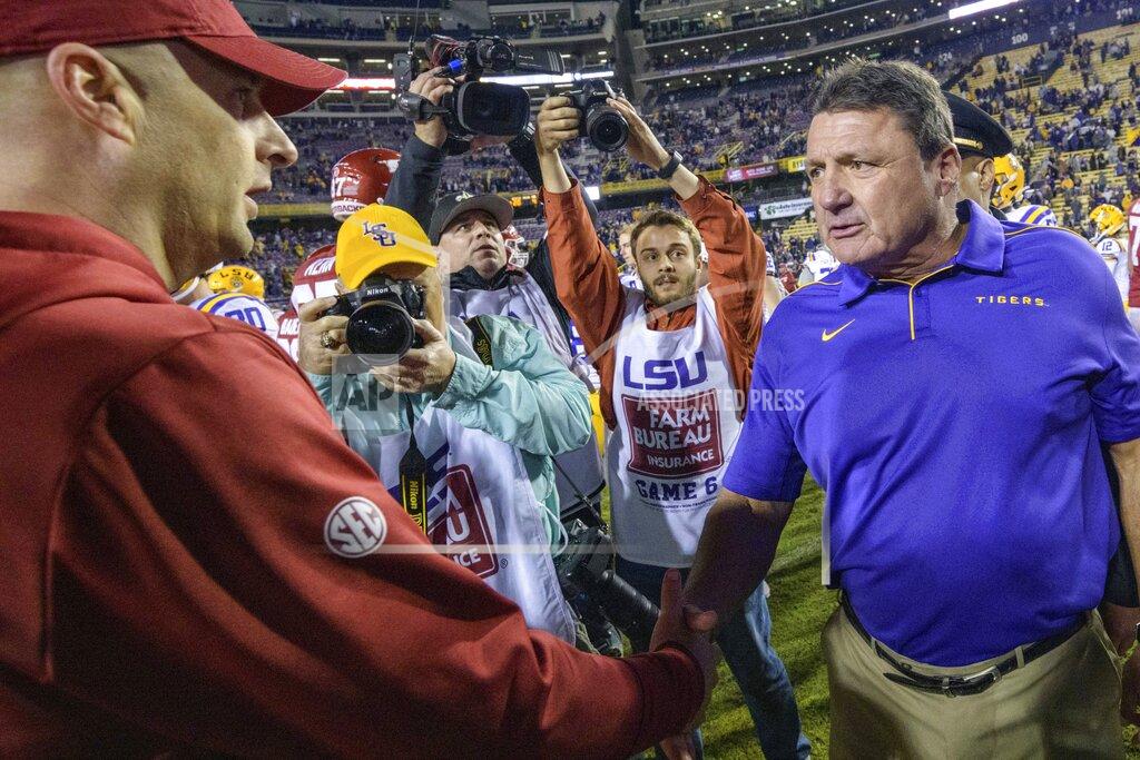 Matthew Hinton LSU coach Ed Orgeron, right, greets Arkansas coach Barry Lunney Jr. after LSU's 56-20 victory in an NCAA college football game in Baton Rouge, La., Saturday, Nov. 23, 2019. (AP Photo/Matthew Hinton)
