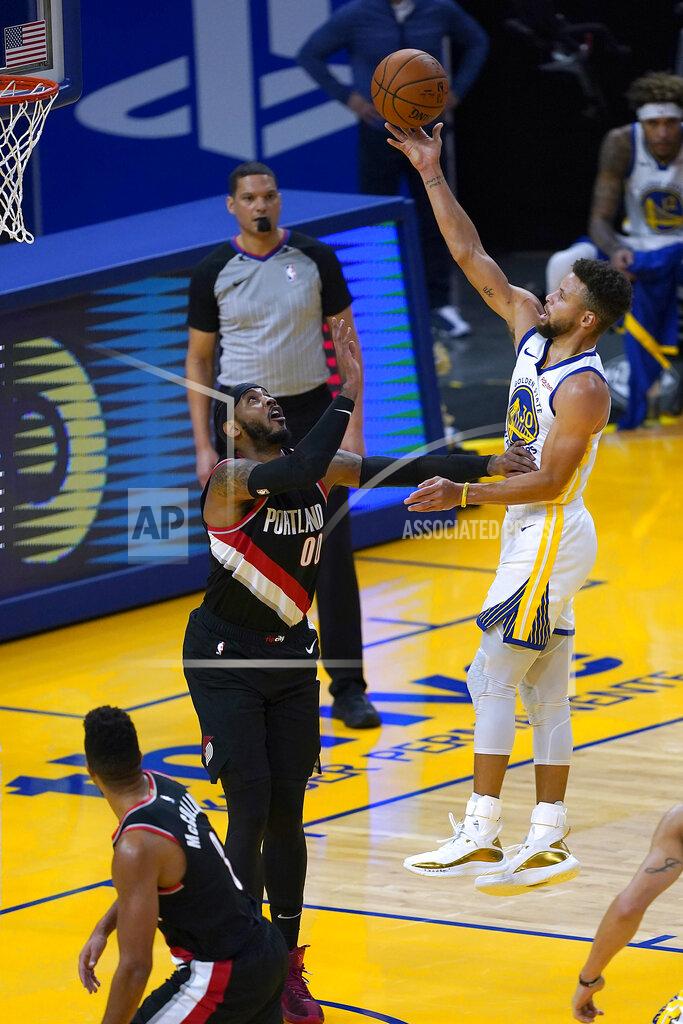 Tony Avelar Golden State Warriors guard Stephen Curry (30) shoots over Portland Trail Blazers forward Carmelo Anthony (00) during the first half of an NBA basketball game in San Francisco, Friday, Jan. 1, 2021. (AP Photo/Tony Avelar)