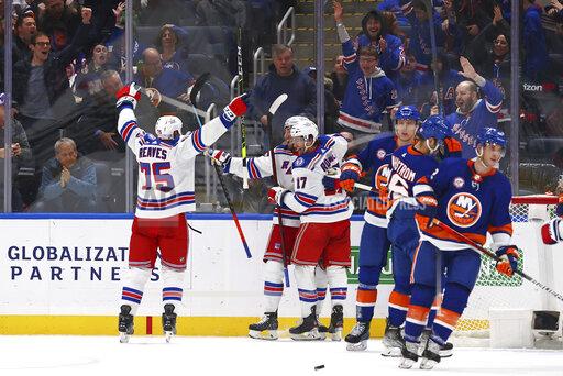 New York Rangers center Kevin Rooney (17) celebrates his goal with right wing Ryan Reaves (75) during the second period of an NHL hockey game against the New York Islanders, Wednesday, Nov. 24, 2021, in Elmont, N.Y. (AP Photo/Rich Schultz)