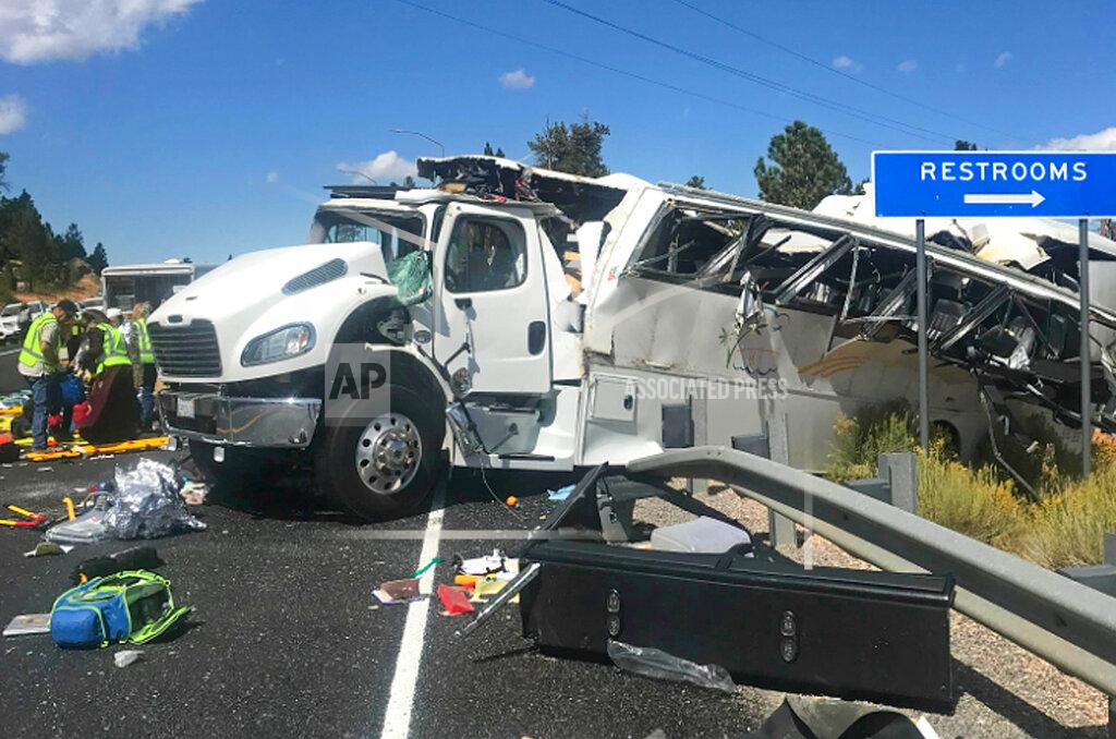 Sheriff Danny Perkins FILE - This Friday, Sept. 20, 2019, file photo released by the Garfield County Sheriff's Office shows a tour bus that was carrying Chinese-speaking tourists after it crashed near Bryce Canyon National Park in southern Utah, killing at least four people and critically injuring up to 15 others. The families of Chinese tourists killed or injured in a 2019 tour bus crash say the state's design and maintenance failed to keep the remote highway safe. More than a dozen people were thrown from the bus when the driver drifted off the road and overcorrected when he steered back, sending the bus into a rollover. A lawsuit alleges the state failed to post warning signs, had a road design that left little room for error and included no rumble strip to warn drivers. The NTSB investigation found a lack of safety standards for bus roofs and windows contributed to death and injury toll. Its final report, released in June, also cited inconsistent seat belt use and recommended a lane-departure warning system for commercial buses. (Sheriff Danny Perkins/Garfield County Sheriff's Office via AP, File)