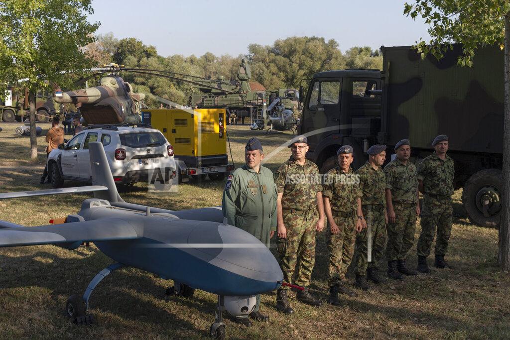 Marko Drobnjakovic Serbian army soldiers stand to attention next to a military drone during an arms display as part of a newly established "Serbian Unity Day" holiday in Belgrade, Serbia, Wednesday, Sept. 15, 2021. Serbia has kicked off a new holiday celebrating national unity with a display of military power, triggering unease among its neighbors. The new holiday comes decades after similar calls for unity led to the bloody wars in the Balkans in the 1990s. Serbs in the region were told to display thousands of red, blue and white national flags wherever they live in the region or the world to mark “The Day of Serb Unity, Freedom and the National Flag.” Serbian officials are calling for the creation of a “Serb World,” or political unification of an estimated 1.3 million Serbs who live in Bosnia, Montenegro, Kosovo and Croatia with Serbia. (AP Photo/Marko Drobnjakovic)