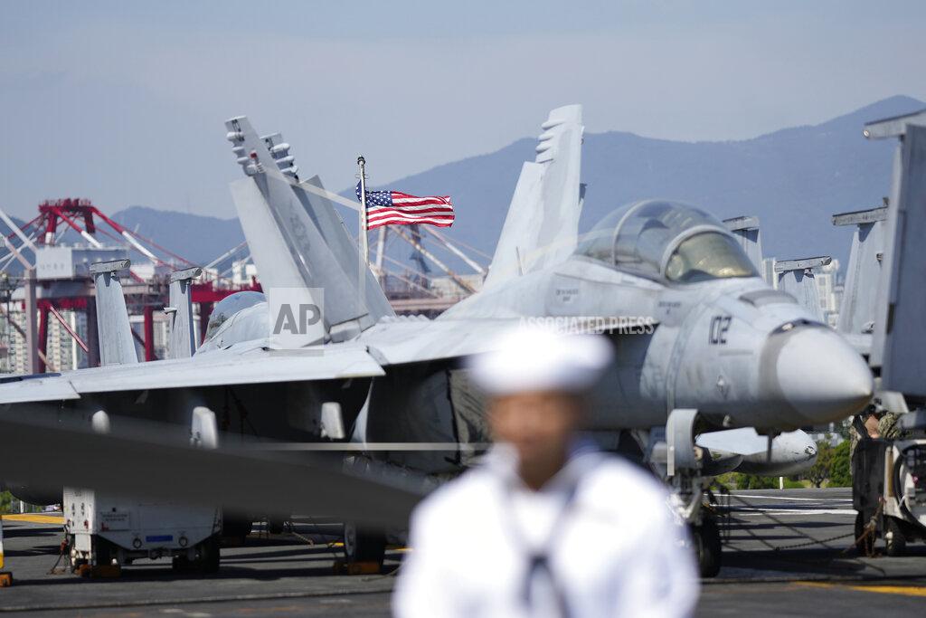 Lee Jin-Man A U.S. flag flutters in the wind near the F/A-18 Super Hornet fighter jet on the deck of the aircraft carrier USS Ronald Reagan in Busan, South Korea, Friday, Sept. 23, 2022. The nuclear-powered aircraft carrier arrived in Busan port on Friday ahead of the two countries' joint military exercise that aims to show their strength against growing North Korean threats. (AP Photo/Lee Jin-man)