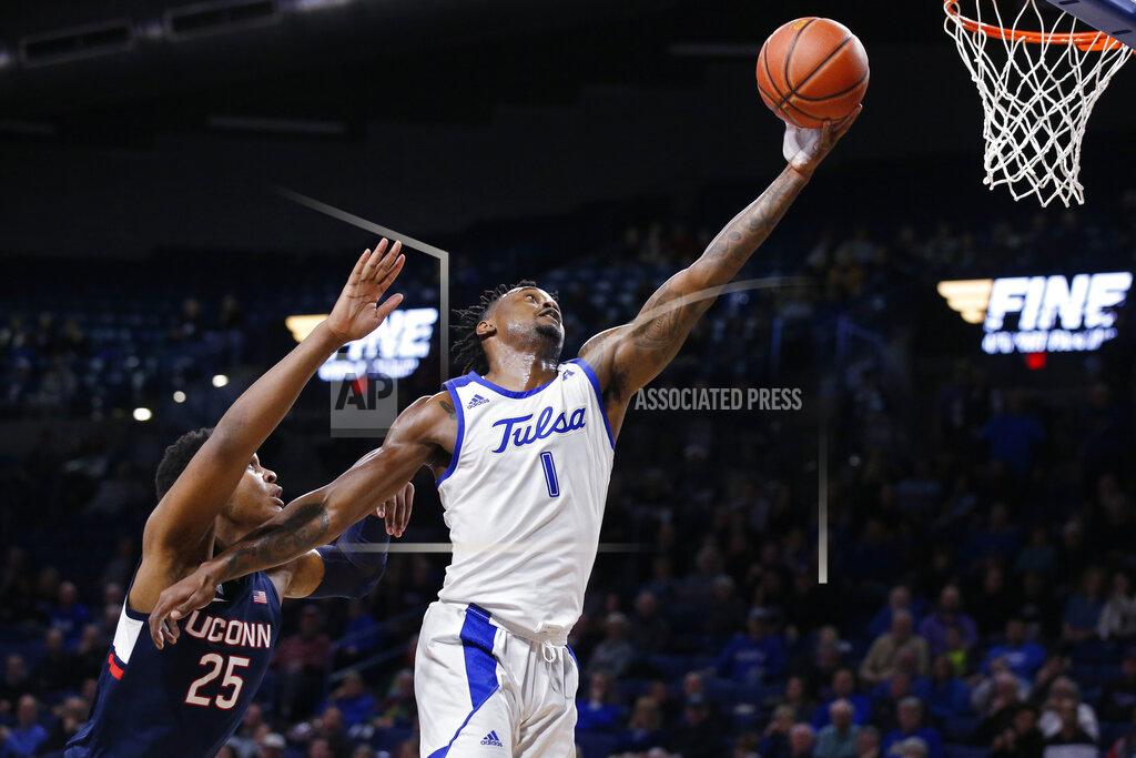 Sue Ogrocki Tulsa forward Martins Igbanu (1) reaches for the ball in front of Connecticut center Josh Carlton (25) during the second half of an NCAA college basketball game in Tulsa, Okla., Thursday, Feb. 6, 2020. (AP Photo/Sue Ogrocki)