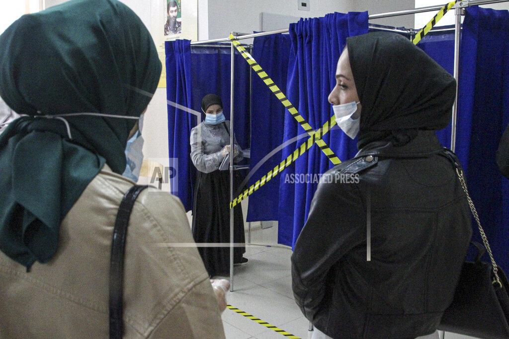 Musa Sadulayev Chechen women wait to fill their ballots in a voting booth at a polling station during the Parliamentary elections in Grozny, Russia, Friday, Sept. 17, 2021. Russia has begun three days of voting for a new parliament that is unlikely to change the country's political complexion. There's no expectation that United Russia, the party devoted to President Vladimir Putin, will lose its dominance in the State Duma. (AP Photo/Musa Sadulayev)