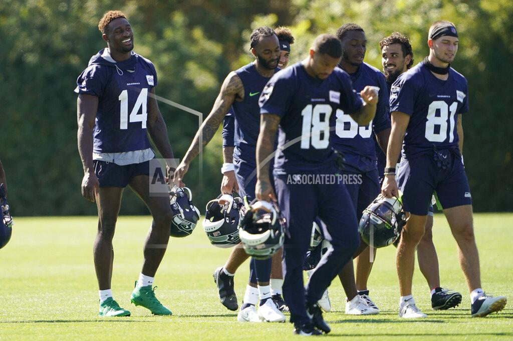 Ted S. Warren Seattle Seahawks wide receiver DK Metcalf (14) laughs as he walks with teammates on the last day of NFL football training camp for the team, Thursday, Sept. 3, 2020, in Renton, Wash. (AP Photo/Ted S. Warren)