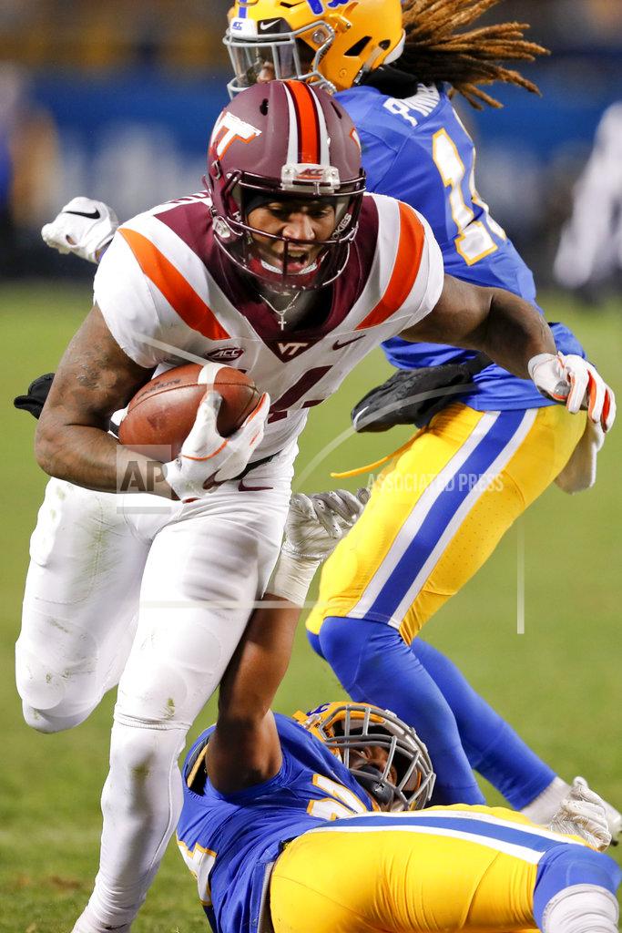 Keith Srakocic Virginia Tech wide receiver Damon Hazelton (14) breaks tackles by Pittsburgh defensive back Jason Pinnock, top, and defensive back Phil Campbell III (24) after catching apss on his way to a touchdown in the fourth quarter of an NCAA football game, Saturday, Nov. 10, 2018, in Pittsburgh. Pittsburgh won 52-22.(AP Photo/Keith Srakocic)