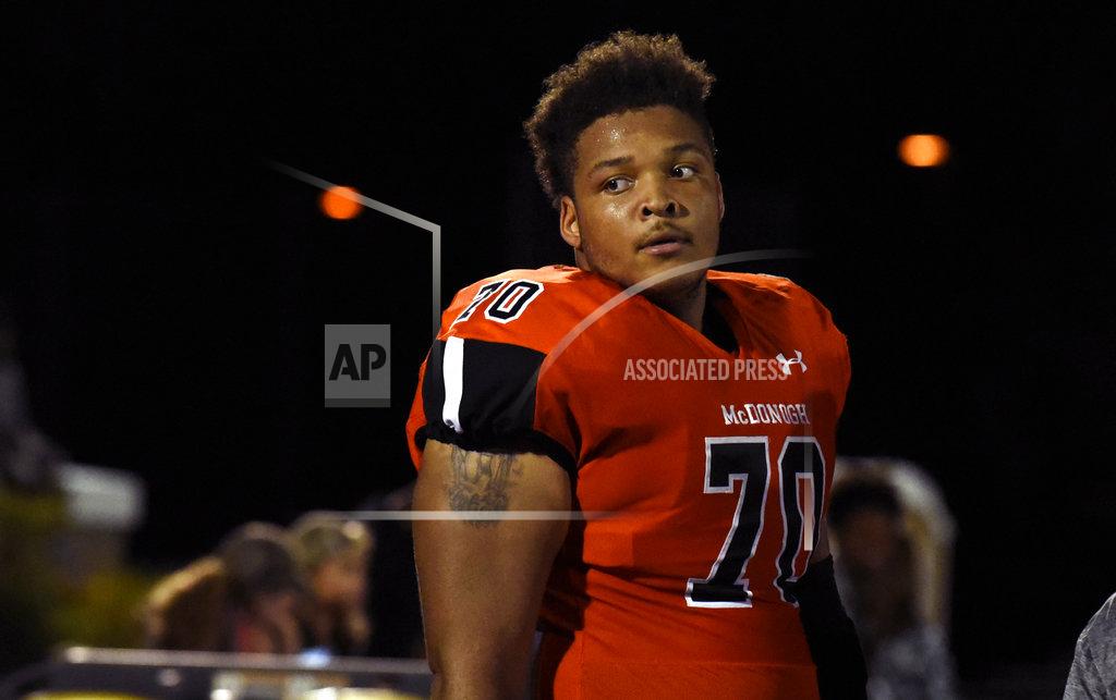 FILE - In this Sept. 16, 2016, file photo, McDonogh high school football lineman Jordan McNair watches from the sideline during a game in McDonogh, Md. Maryland has fired two trainers that were involved in the treatment of Jordan McNair after he collapsed on the field and subsequently died of heatstroke. Maryland has not formally announced the decision and has never named the trainers, but The Associated Press reported in August Wes Robinson and Steve Nordwall had been placed on leave. (Barbara Haddock Taylor/The Baltimore Sun via AP, File)/The Baltimore Sun via AP)