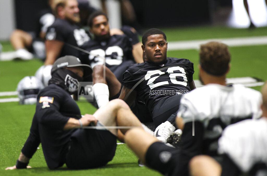 Chase Stevens Las Vegas Raiders running back Josh Jacobs (28) stretches with teammates during an NFL football training camp practice Sunday, Aug. 16, 2020, in Henderson, Nev. (Chase Stevens/Las Vegas Review-Journal via AP, Pool)