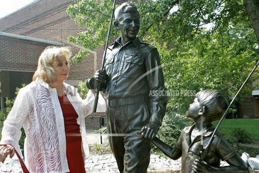 FILE - In this Sept. 6, 2007 file photo, actor Betty Lynn, who played Thelma Lou on "The Andy Griffith Show," pauses at a statue of Andy and Opie Taylor in Mount Airy, N.C. Lynn died Saturday, Oct. 16, 2021, after a brief illness, The Andy Griffith Museum in Mount Airy announced in a statement. She was 95. (AP Photo/Gerry Broome, File)