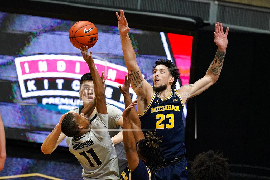 Michael Conroy Michigan forward Brandon Johns Jr. (23) goes up to block the shot of Purdue guard Isaiah Thompson (11) during the first half of an NCAA college basketball game in West Lafayette, Ind., Friday, Jan. 22, 2021. (AP Photo/Michael Conroy)