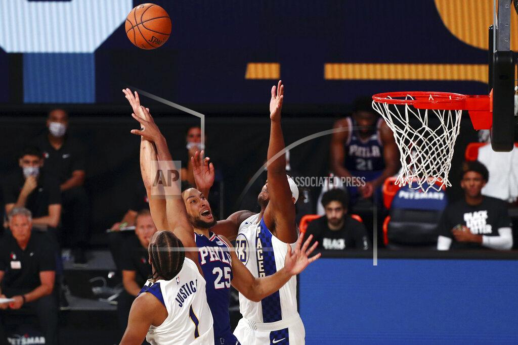 Kim Klement Philadelphia 76ers guard Ben Simmons (25) shoots against Indiana Pacers center Myles Turner (33) and forward T.J. Warren (1) during the fourth quarter of an NBA basketball game Saturday, Aug. 1, 2020, in Lake Buena Vista, Fla. (Kim Klement/Pool Photo via AP)