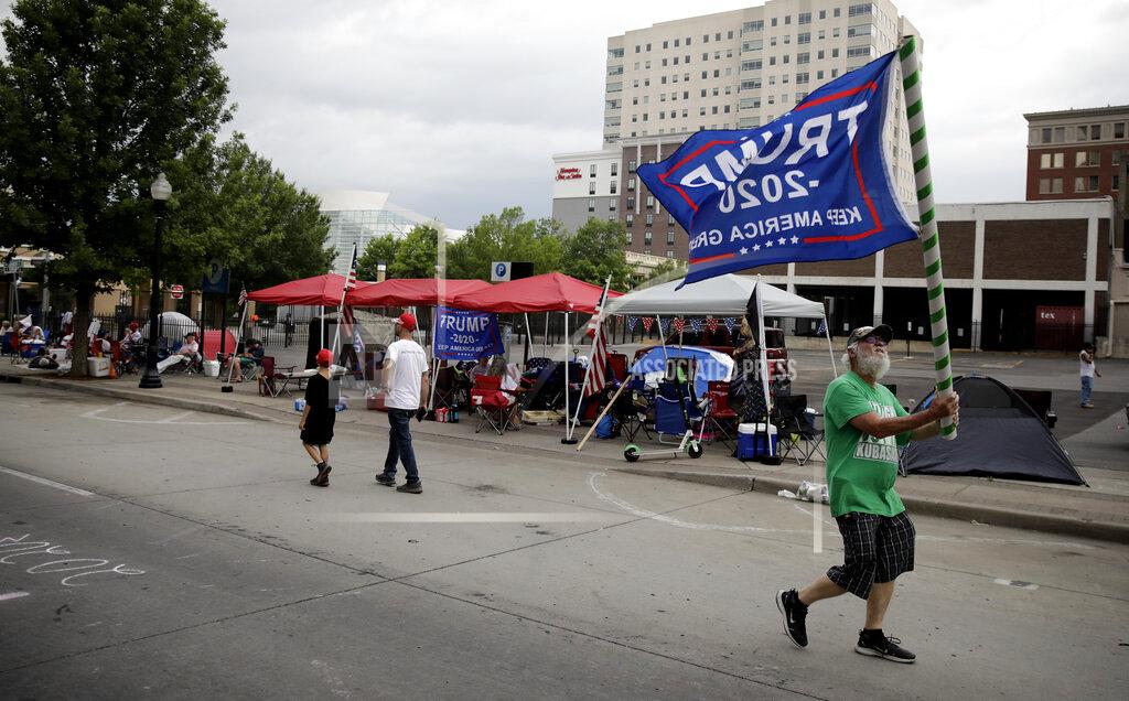 Mike Pellerin joins other Trump supporters on 4th Street and Cheyenne Ave. in downtown Tulsa, Okla., ahead of President Donald Trump's Saturday's campaign rally Friday, June 19, 2020. (Mike Simons/Tulsa World via AP)
