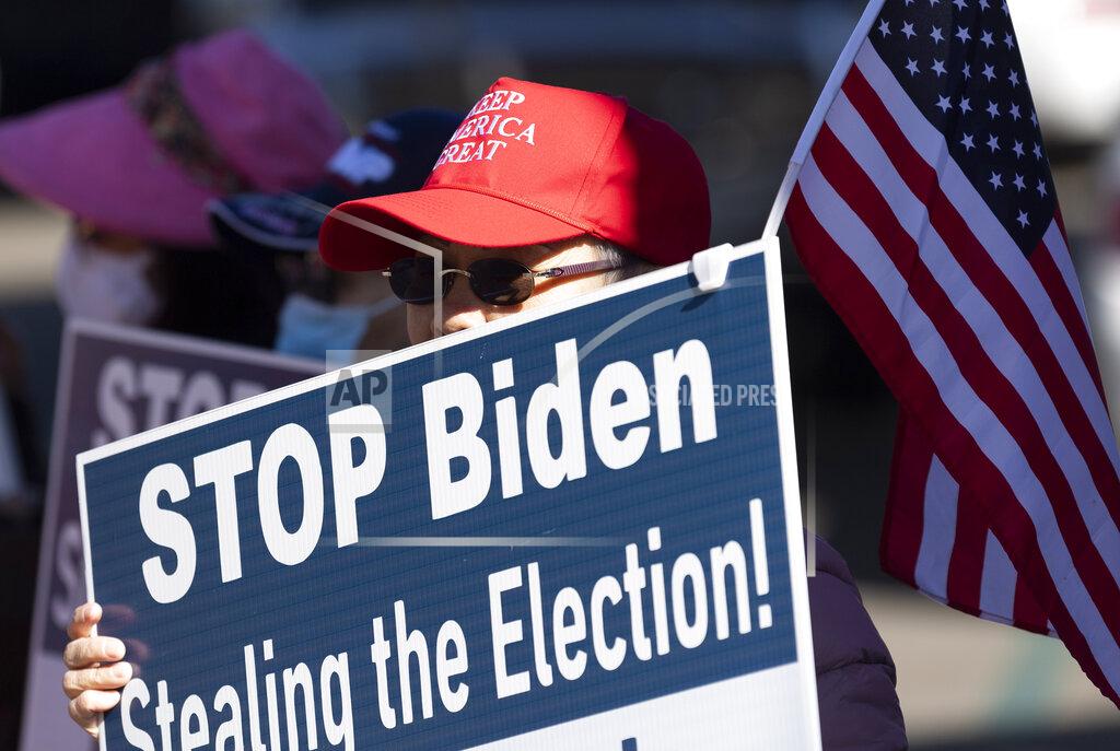 Paul Bersebach A woman participates in a pro-Trump election integrity rally at the Orange County Registrar of Voters offices in Santa Ana, Calif., Monday, Nov. 9, 2020. The rally was calling attention to what organizers see as a broken national election process that involve corrupt voter rolls, computer vote flipping and dumping illegal paper ballots into the system around the country. They were not protesting the O.C. Registrar's office. (Paul Bersebach/The Orange County Register via AP)