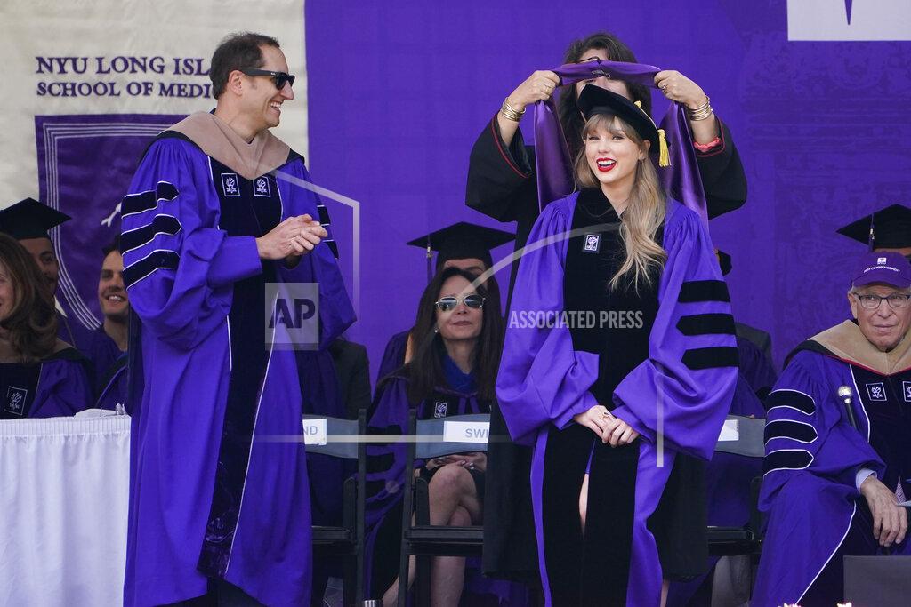 Seth Wenig Taylor Swift, right, receives an honorary degree during a graduation ceremony for New York University at Yankee Stadium in New York, Wednesday, May 18, 2022. (AP Photo/Seth Wenig)