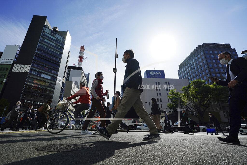 Eugene Hoshiko People wearing protective masks to help curb the spread of the coronavirus walk a street in Tokyo on April 15, 2021. The picture is still grim in parts of Europe and Asia as variants of the virus fuel an increase in new cases and the worldwide death toll closes in on 3 million. (AP Photo/Eugene Hoshiko)
