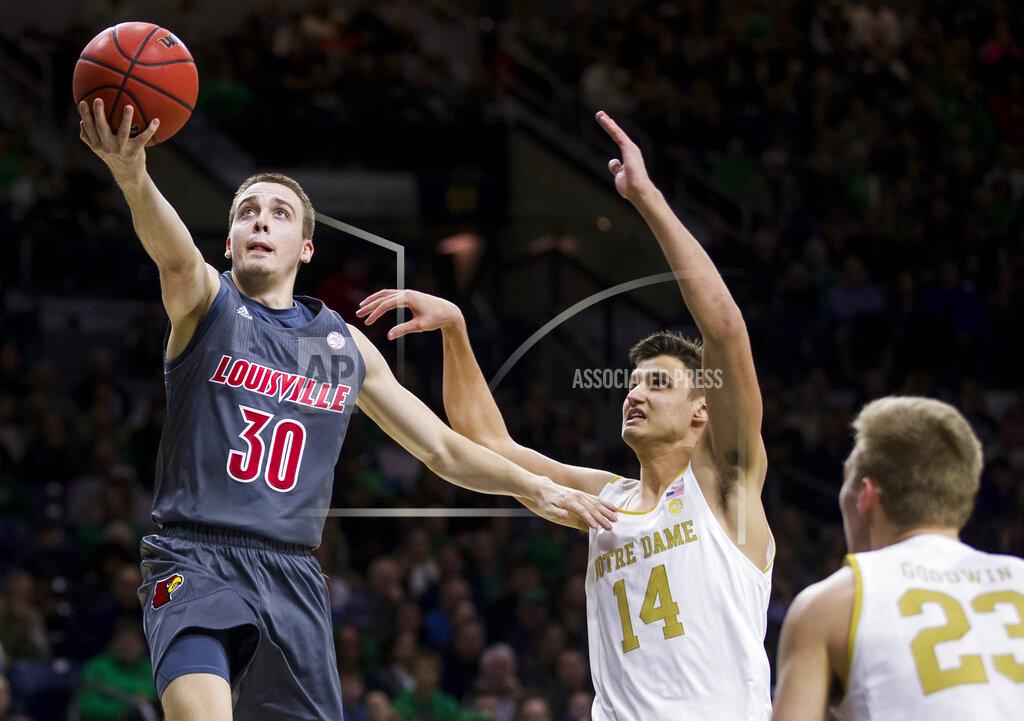 Robert Franklin Louisville's Ryan McMahon (30) goes up for a shot over Notre Dame's Nate Laszewski (14) and Dane Goodwin (23) during the first half of an NCAA college basketball game Saturday, Jan. 11, 2020, in South Bend, Ind. (AP Photo/Robert Franklin)