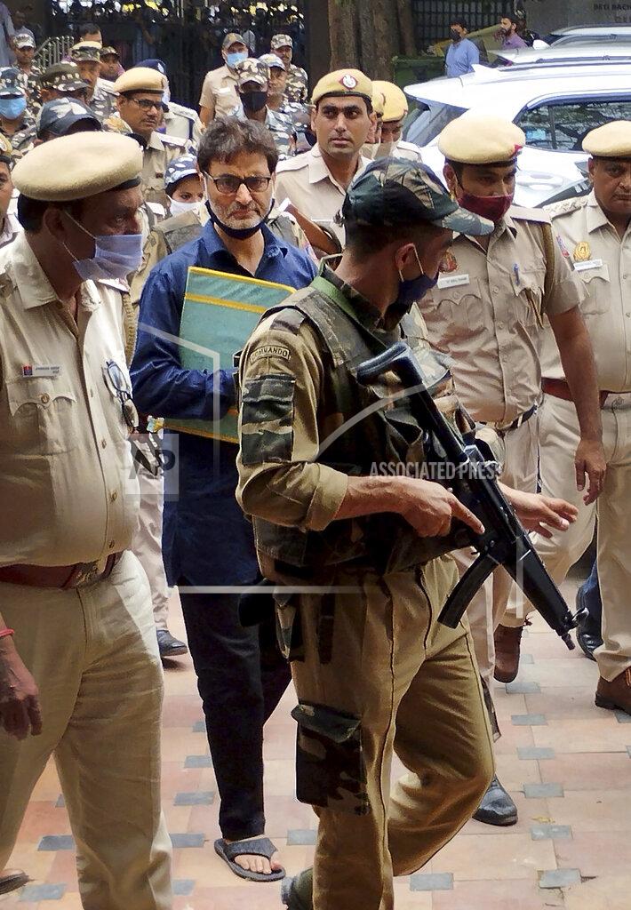 Dinesh Joshi Kashmiri separatist leader Yasin Malik is escorted by police officers to a court in New Delhi, India, Wednesday, May 25, 2022. An Indian court on Wednesday sentenced a Kashmiri separatist leader to life in prison after finding him guilty of terrorism and sedition, triggering an anti-India protest and partial shutdown of businesses in the Indian-controlled portion of disputed Kashmir. (AP Photo/Dinesh Joshi)