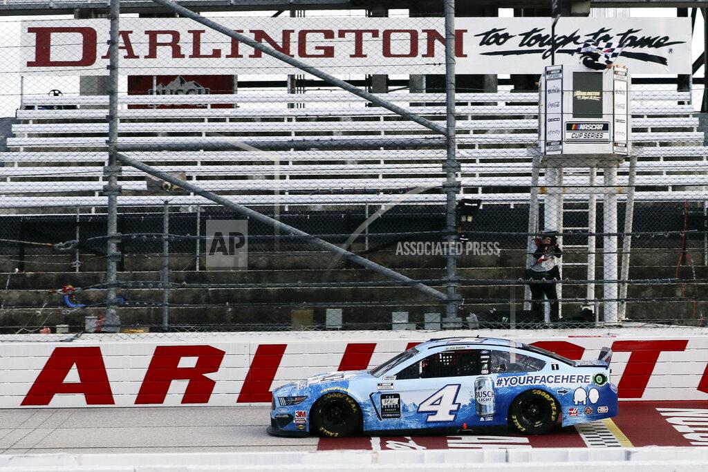 Brynn Anderson Kevin Harvick (4) crosses the finish line to win the NASCAR Cup Series auto race Sunday, May 17, 2020, in Darlington, S.C. (AP Photo/Brynn Anderson)