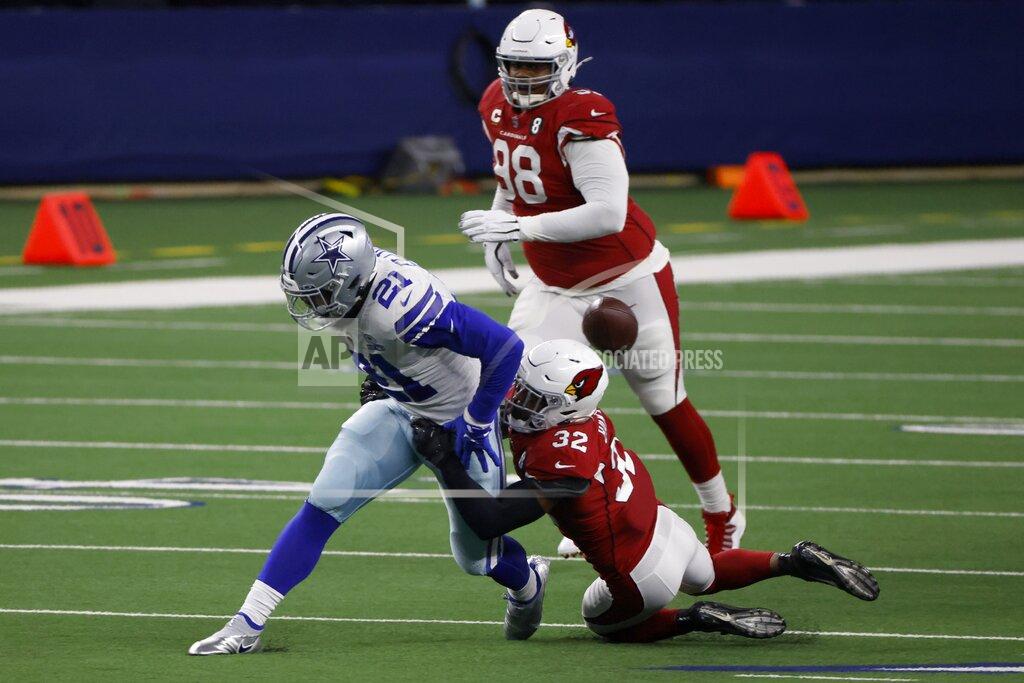 Ron Jenkins Dallas Cowboys running back Ezekiel Elliott (21) has the ball stripped away by Arizona Cardinals safety Budda Baker (32) as defensive tackle Corey Peters (98) looks on in the first half of an NFL football game in Arlington, Texas, Monday, Oct. 19, 2020. (AP Photo/Ron Jenkins)