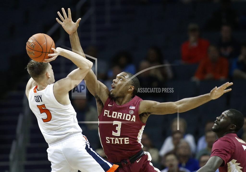 Nell Redmond Virginia's Kyle Guy (5) tries to shoot over Florida State's Trent Forrest (3) during the first half of an NCAA college basketball game in the Atlantic Coast Conference tournament in Charlotte, N.C., Friday, March 15, 2019. (AP Photo/Nell Redmond)