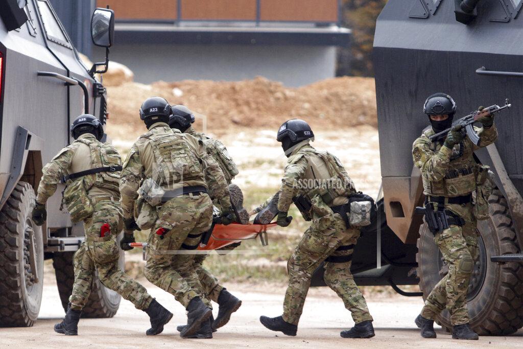 Uncredited Members of the police forces of Bosnia's Serb-run part carry a stretcher during exercises on the Jahorina Mountain, Bosnia and Herzegovina, Friday, Oct. 22, 2021. The exercises on Jahorina Mountain, outside Sarajevo, and in the northern town of Mrkonjic Grad, were staged just days after Bosnian Serb top leader, Milorad Dodik, announced that the country's Serb-run part will quit the key multi-ethnic state institutions. (AP Photo)