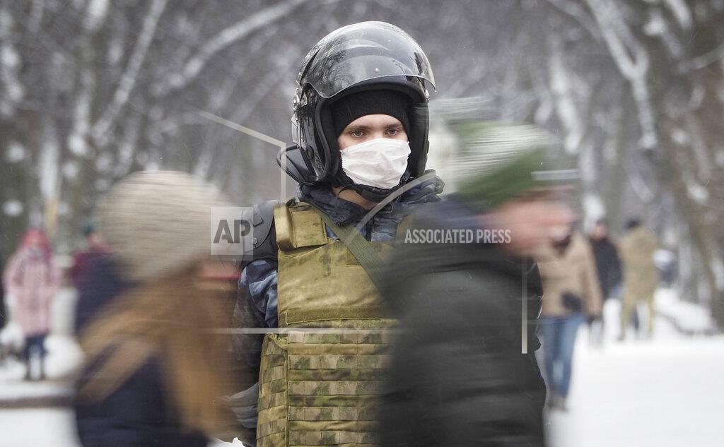 Dmitri Lovetsky A Russian Rosguardia (National Guard) soldier stands at a central avenue a day before Sunday's protest in St. Petersburg, Russia, Saturday, Jan. 30, 2021. As part of a multipronged effort by the authorities to discourage Russians from attending Sunday's demonstrations, the Prosecutor General's office ordered the state communications watchdog, Roskomnadzor, to block the calls for joining the protests on the internet. The Prosecutor General's office and the Interior Ministry also issued stern warnings to the public not to join the protests, saying participants could face criminal charges of taking part in mass riots if the rallies turn violent. (AP Photo/Dmitri Lovetsky)