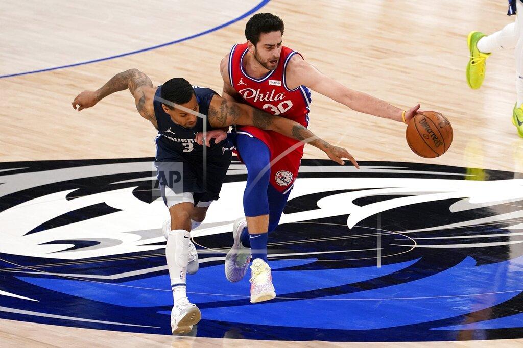 Tony Gutierrez Dallas Mavericks guard Trey Burke (3) competes against Philadelphia 76ers guard Furkan Korkmaz (30) for control of a loose ball in the second half of an NBA basketball game in Dallas, Monday, April 12, 2021. (AP Photo/Tony Gutierrez)