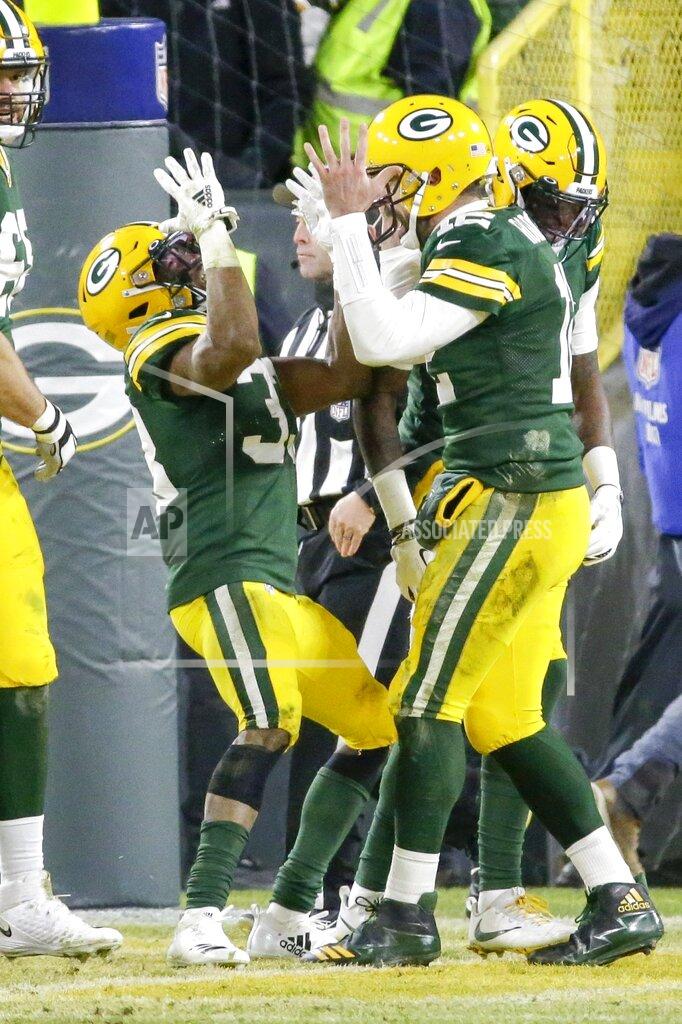 Mike Roemer Green Bay Packers' Aaron Rodgers celebrates with Aaron Jones (33) after a touchdown run during the first half of an NFL divisional playoff football game against the Seattle Seahawks Sunday, Jan. 12, 2020, in Green Bay, Wis. (AP Photo/Mike Roemer)