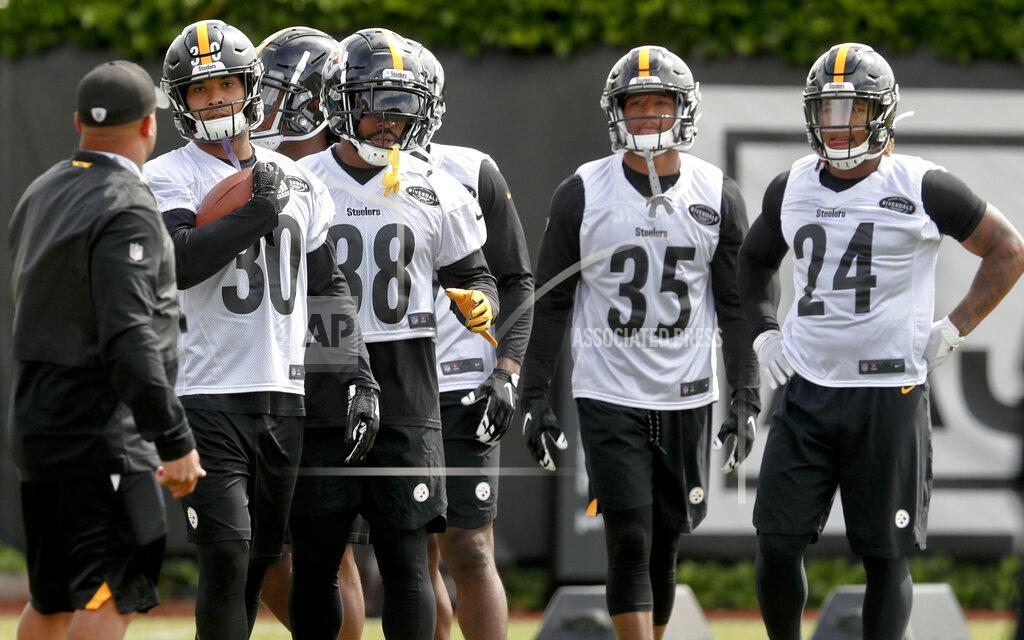 Keith Srakocic FILE - This May 21, 2019, file photo shows Pittsburgh Steelers running backs coach Eddie Faulkner, left, instructing James Conner (30), Jaylen Samuels (38), Travon McMillian (35), and Benny Snell Jr. (24) during an NFL football practice in Pittsburgh. Conner doesn't have to answer questions about Le'Veon Bell anymore. He is firmly entrenched as the starter entering his third season but welcomes the chance to share the load with Jaylen Samuels and rookie Benny Snell Jr. (AP Photo/Keith Srakocic, File)