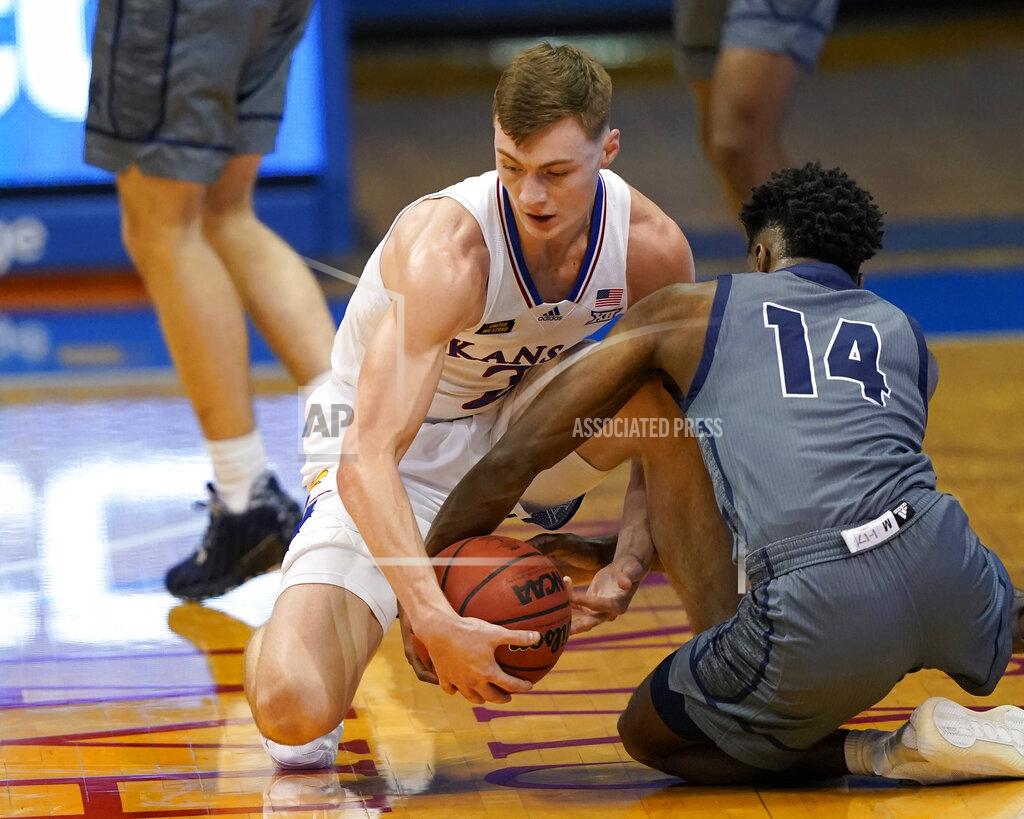 Orlin Wagner Kansas guard Christian Braun (2) and Washburn guard Tyler Nelson (14) compete for a loose ball during the first half of an NCAA college basketball game in Lawrence, Kan., Thursday, Dec. 3, 2020. (AP Photo/Orlin Wagner)