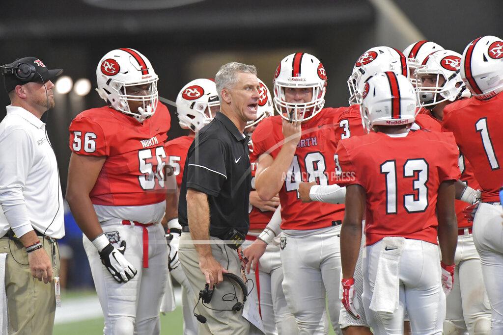 Hyosub Shin In this Aug. 24, 2019 photo, North Gwinnett head coach Bill Stewart instructs his team in the second half of the Corky Kell Classic high school football game against Colquitt County at Mercedes-Benz Stadium in Atlanta. Georgia has become the clear No. 4 state behind Texas, Florida and California for producing major college football players. (Hyosub Shin/Atlanta Journal-Constitution via AP)