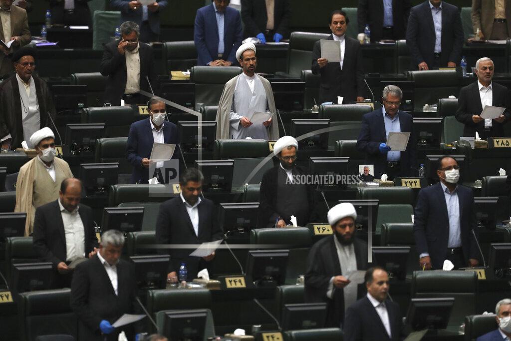 Vahid Salemi Lawmakers are sworn in during the inauguration of Iran's new parliament, in Tehran, Iran, Wednesday, May, 27, 2020. Iran has convened its newly elected parliament, dominated by conservative lawmakers and under strict social distancing regulations, as the country struggles to curb the spread of coronavirus that has hit the nation hard. Iran is grappling with one of the deadliest outbreaks in the Middle East. (AP Photo/Vahid Salemi)