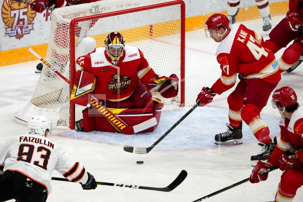 Alexander Zemlianichenko FILE - Russia hockey club Amur Khabarovsk's Danil Faizullin, left, tries to score against Kunlun Red Star's goalie Jeremy Smith, center, as Kunlun Red Star's Cory Kane, right, tries to block during a Kontinental Hockey League ice hockey in Mytishchi, just outside Moscow, Russia, Monday, Nov. 15, 2021. Host China has finalized its roster for the men's hockey tournament at the Beijing Olympics. American Jeremy Smith is expected to be China's starting goaltender. (AP Photo/Alexander Zemlianichenko, File)