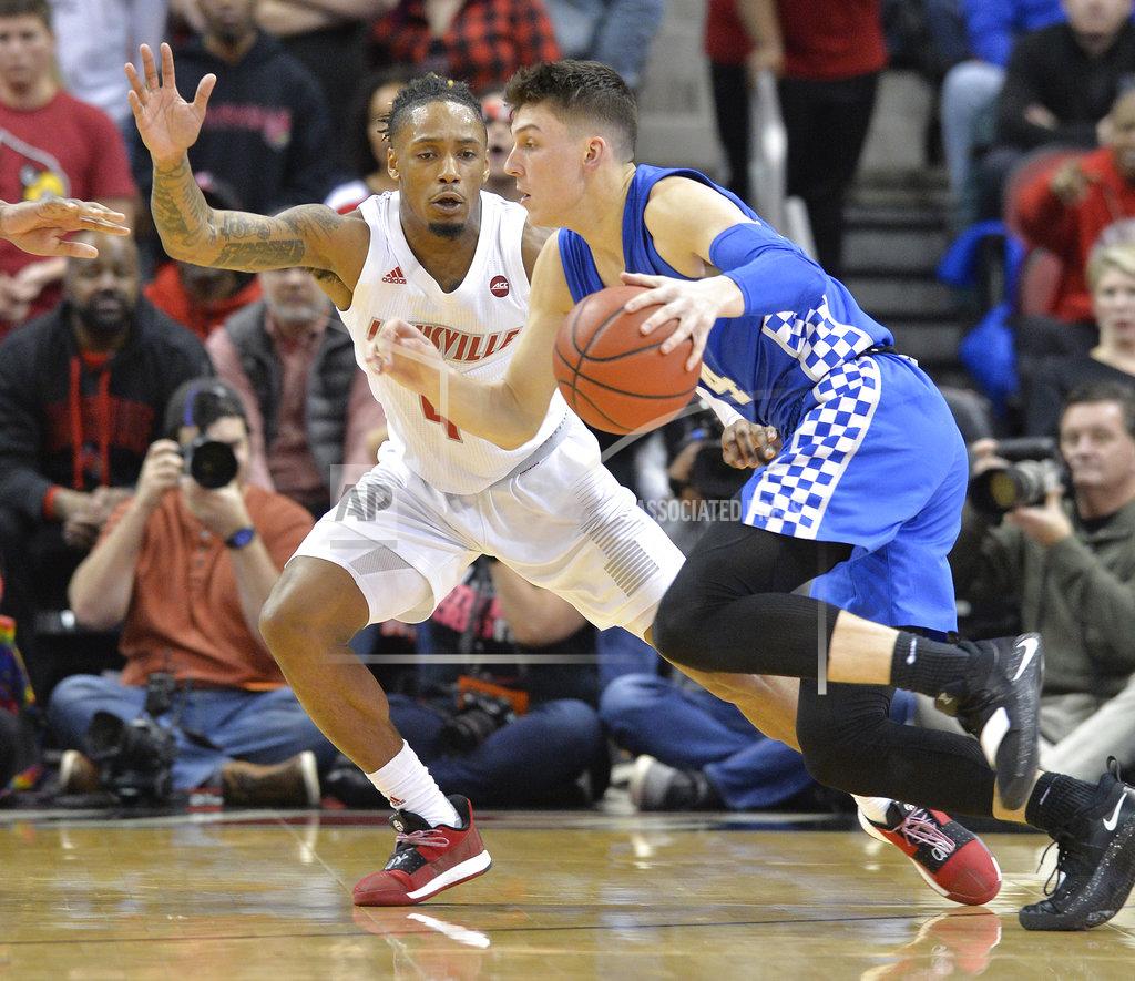 Timothy D. Easley Kentucky guard Tyler Herro (14) attempts to drive past the defense of Louisville guard Khwan Fore (4) during the second half of an NCAA college basketball game in Louisville, Ky., Saturday, Dec. 29, 2018. Kentucky won 71-58. (AP Photo/Timothy D. Easley)