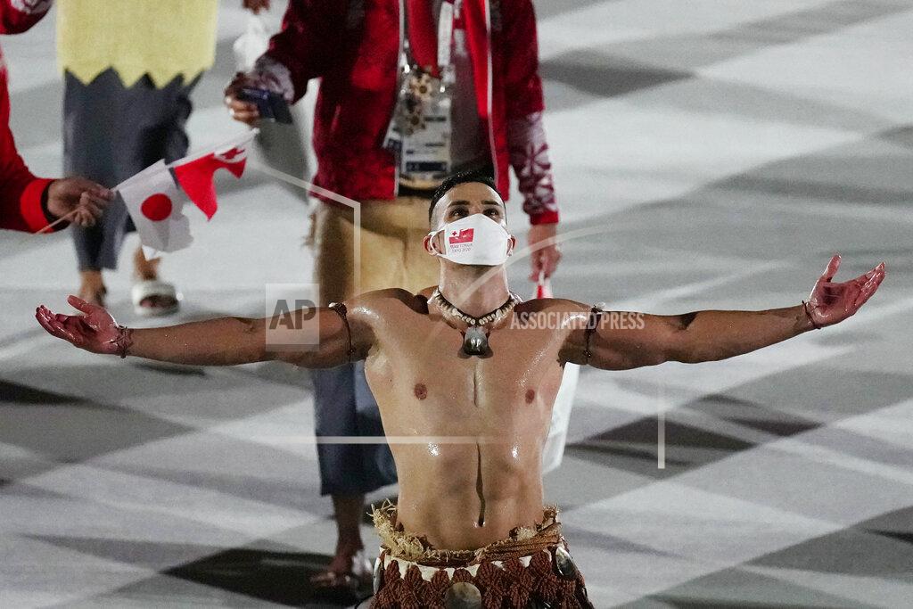 David J. Phillip Pita Taufatofua, of Tonga, walks during the opening ceremony in the Olympic Stadium at the 2020 Summer Olympics, Friday, July 23, 2021, in Tokyo, Japan. (AP Photo/David J. Phillip)