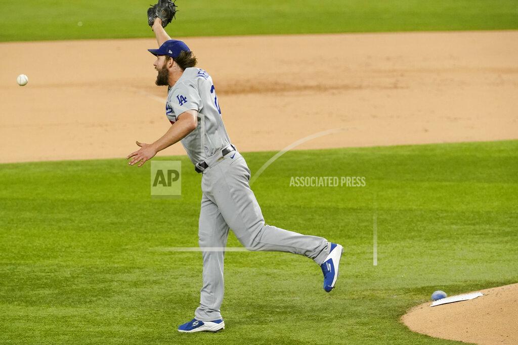 Tony Gutierrez Los Angeles Dodgers starting pitcher Clayton Kershaw can't get a glove on a base hit by Atlanta Braves' Ronald Acuna Jr. during the sixth inning in Game 4 of a baseball National League Championship Series Thursday, Oct. 15, 2020, in Arlington, Texas. (AP Photo/Tony Gutierrez)