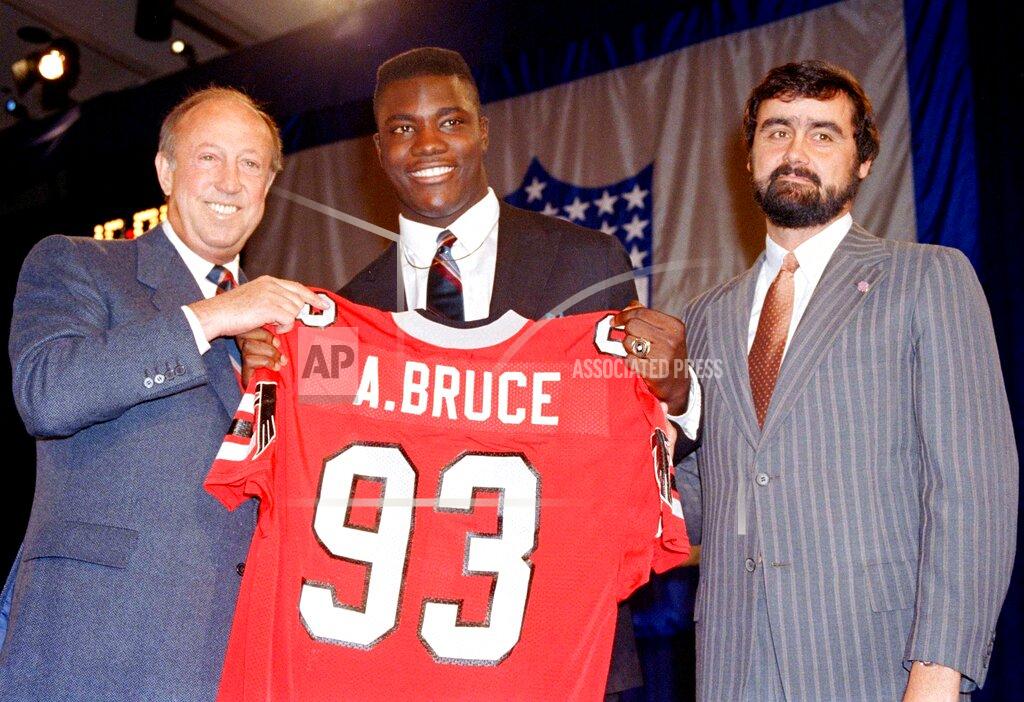 Ron Frehm FILE - In this April 24, 1988, file photo, Aundray Bruce, center, holds up his future jersey with help from NFL commissioner Pete Rozelle, left, and Rankin Smith Jr., president of the Atlanta Falcons, at the Marriott Marquis Hotel in New York. Bruce was heralded as the next Lawrence Taylor when he arrived from Auburn in 1988, but he's now remembered as one of the most notorious busts in NFL history. (AP Photo/Ron Frehm, File)