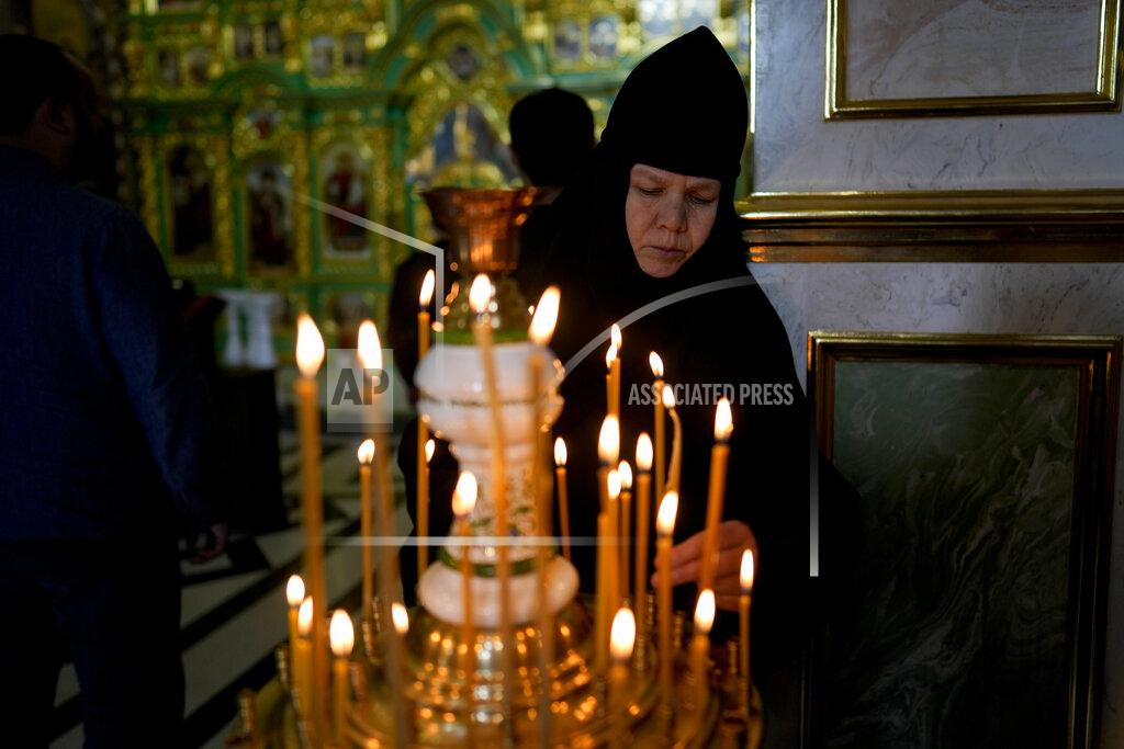 Natacha Pisarenko A nun attends a mass at Kyiv Pechersk Lavra Monastery in Kyiv, Ukraine, Saturday, May 28, 2022. The leaders of the Orthodox churches in Ukraine that were affiliated with the Russian Orthodox Church have announced on a statement they will sever ties with Russia over its invasion of Ukraine. (AP Photo/Natacha Pisarenko)