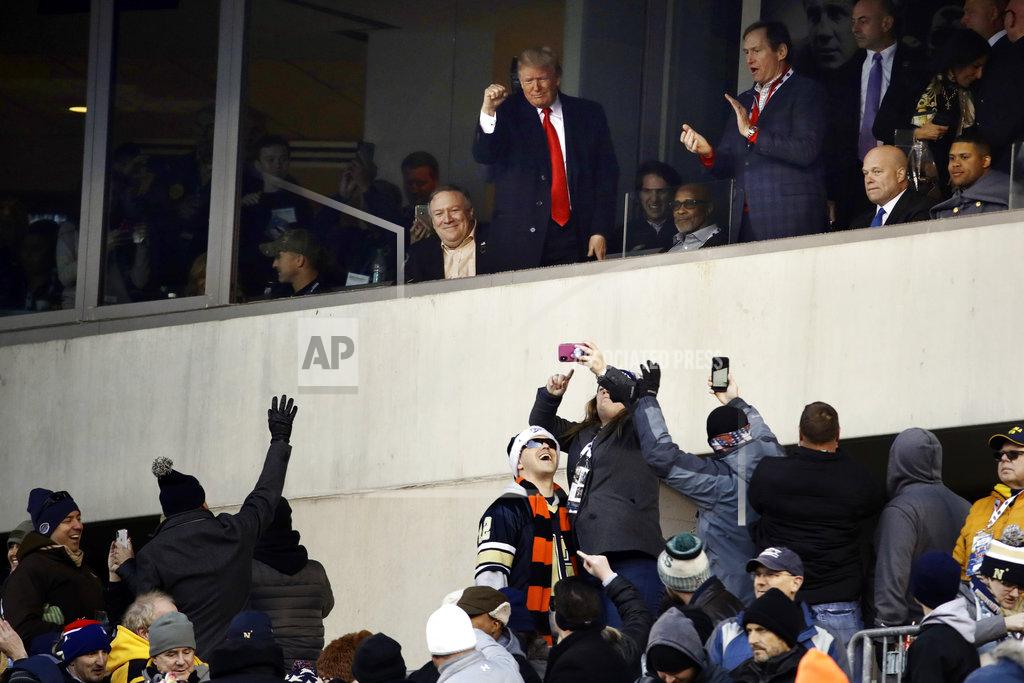 Matt Rourke President Donald Trump, top center, gestures to the crowd during the first half of an NCAA college football game between Army and Navy, Saturday, Dec. 8, 2018, in Philadelphia. (AP Photo/Matt Rourke)