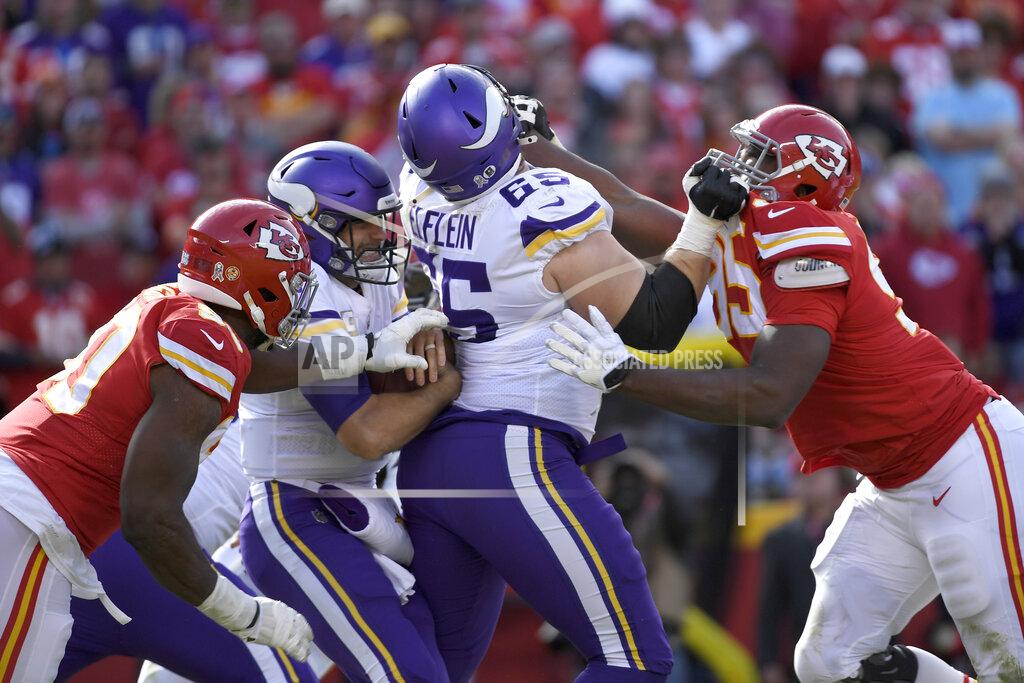 Reed Hoffmann Kansas City Chiefs defensive end Emmanuel Ogbah, left, sacks Minnesota Vikings quarterback Kirk Cousins, second left, as Minnesota Vikings offensive guard Pat Elflein (65) blocks Kansas City Chiefs defensive tackle Chris Jones (95), in the first half of an NFL football game in Kansas City, Mo., Sunday, Nov. 3, 2019. (AP Photo/Reed Hoffmann)