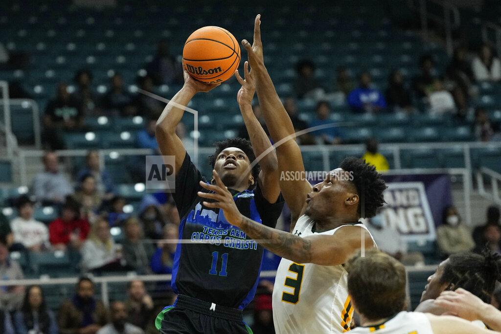 David J. Phillip Texas A&M Corpus Christi's Terrion Murdix (11) goes up for a shot as Southeastern Louisiana's Roger McFarlane (3) defends during the second half of the Southland Conference tournament NCAA college basketball game final Saturday, March 12, 2022, in Katy, Texas. Texas A&M Corpus Christi won 73-65.(AP Photo/David J. Phillip)