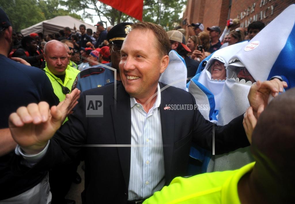 Bruce Newman FILE - In this Oct. 24, 2015, file photo, Ole Miss Rebels head coach Hugh Freeze walks through fans on the way to the stadium in Oxford, Miss. Liberty has hired former Mississippi coach Hugh Freeze to lead its football program. A person familiar with the situation told The Associated Press that the Flames have tabbed Freeze as their next coach. The person spoke to the AP on the condition of anonymity because neither the school nor Freeze has publicly announced the decision. Liberty has scheduled a news conference to "name Liberty's next head football coach" for Friday afternoon, Dec. 7, 2018. (Bruce Newman/The Oxford Eagle via AP, File)