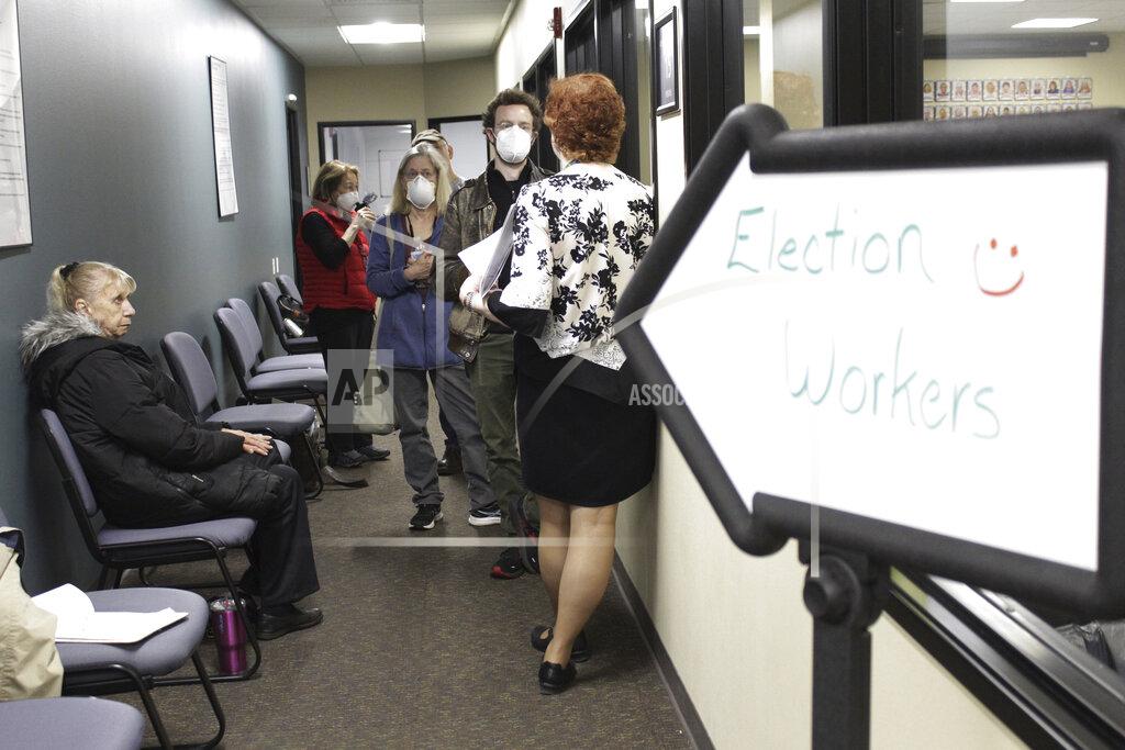 Gillian Flaccus Observers speak with Clackamas County Elections Clerk Sherry Hall, right, as election workers review ballots on Thursday, May 19, 2022, Oregon City, Ore. Ballots with blurry barcodes that can't be read by vote-counting machines will delay election results by weeks in a key U.S. House race in Oregon's primary. (AP Photo/Gillian Flaccus)