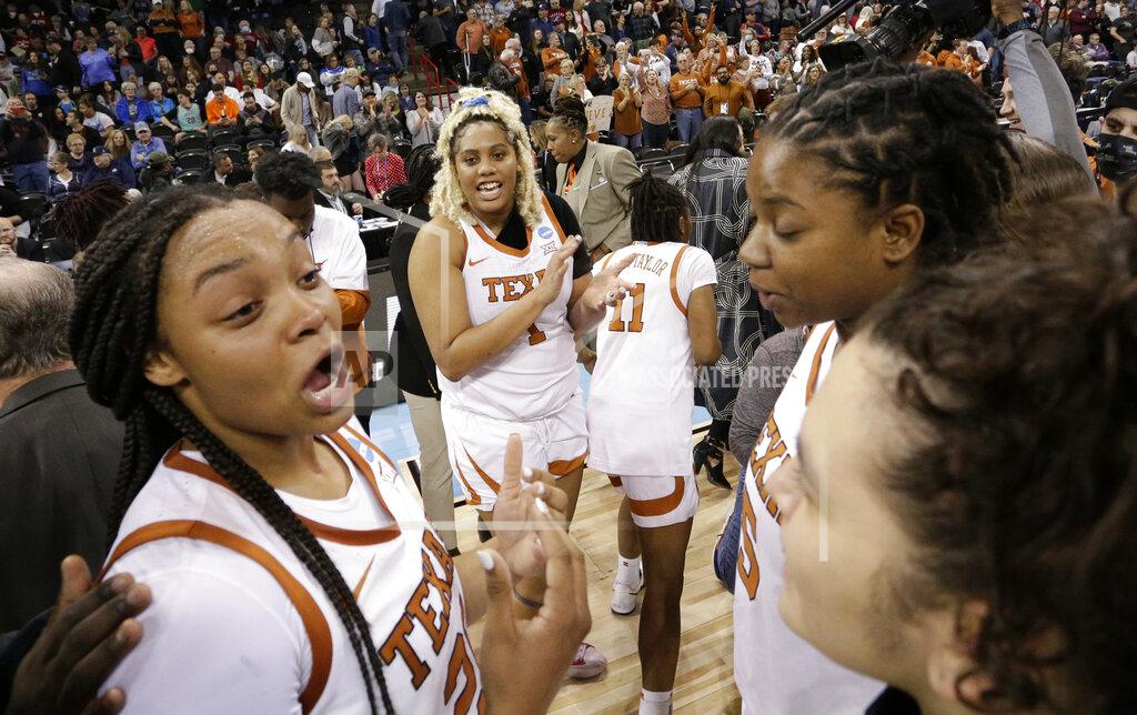 Young Kwak Texas players react on the court after they beat Ohio State 66-63 in a college basketball game in the Sweet 16 round of the NCAA tournament, Friday, March 25, 2022, in Spokane, Wash. (AP Photo/Young Kwak)