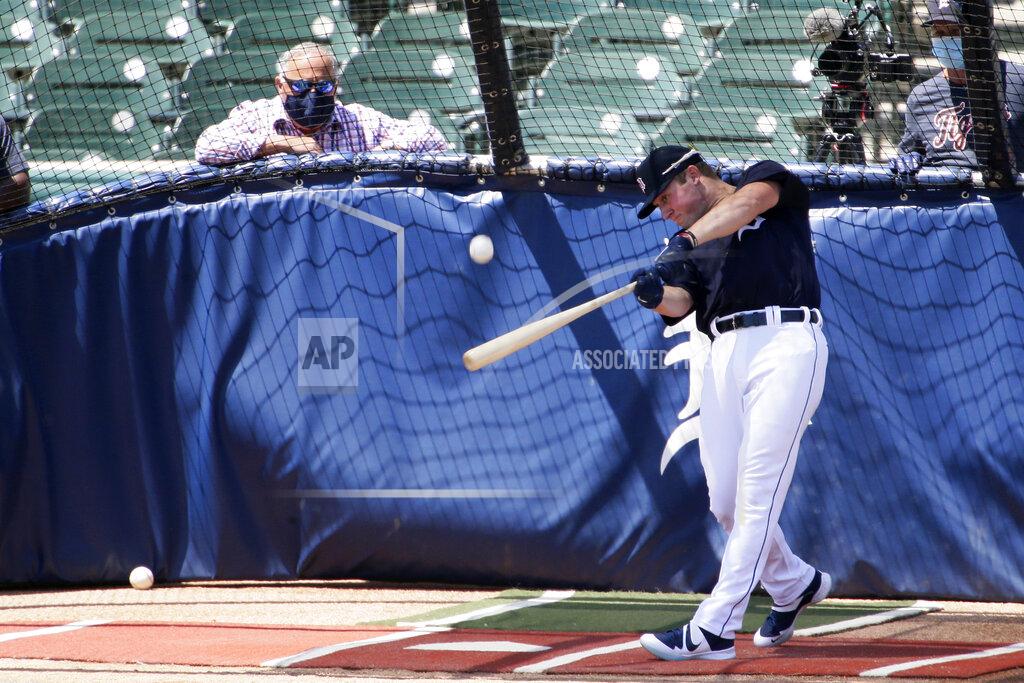 Duane Burleson Detroit Tigers' Spencer Torkelson hits in the batting cage as Tigers general manager Al Avila, left, watches during baseball training camp at Comerica Park Saturday, July 4, 2020, in Detroit. (AP Photo/Duane Burleson)