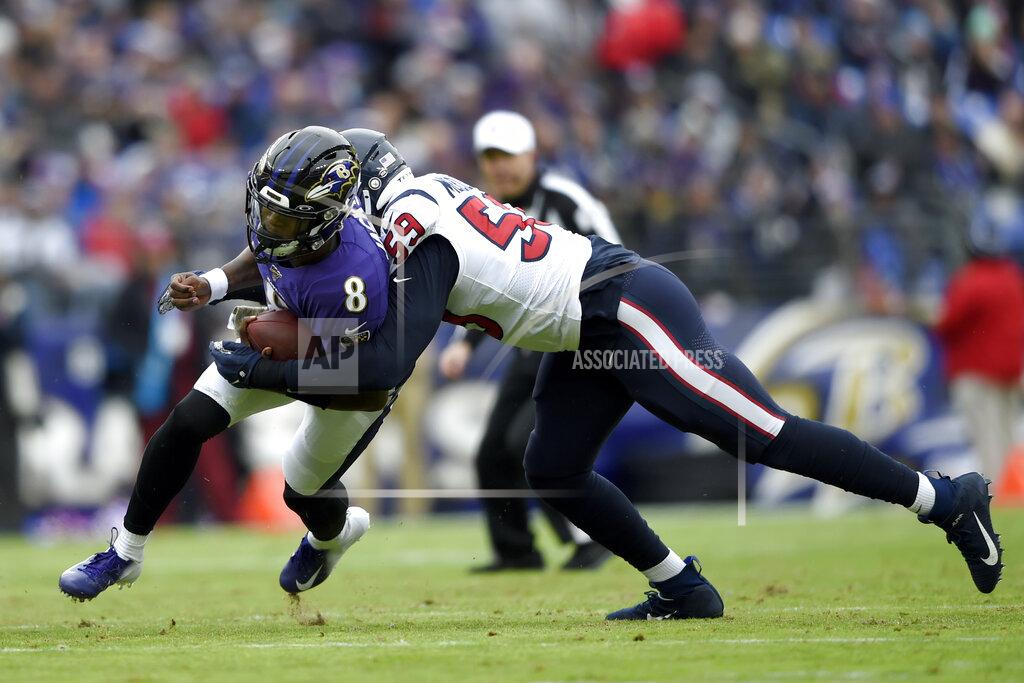Gail Burton Baltimore Ravens quarterback Lamar Jackson (8 runs with the ball as Houston Texans outside linebacker Whitney Mercilus (59) makes the tackle during the first half of an NFL football game, Sunday, Nov. 17, 2019, in Baltimore. (AP Photo/Gail Burton)