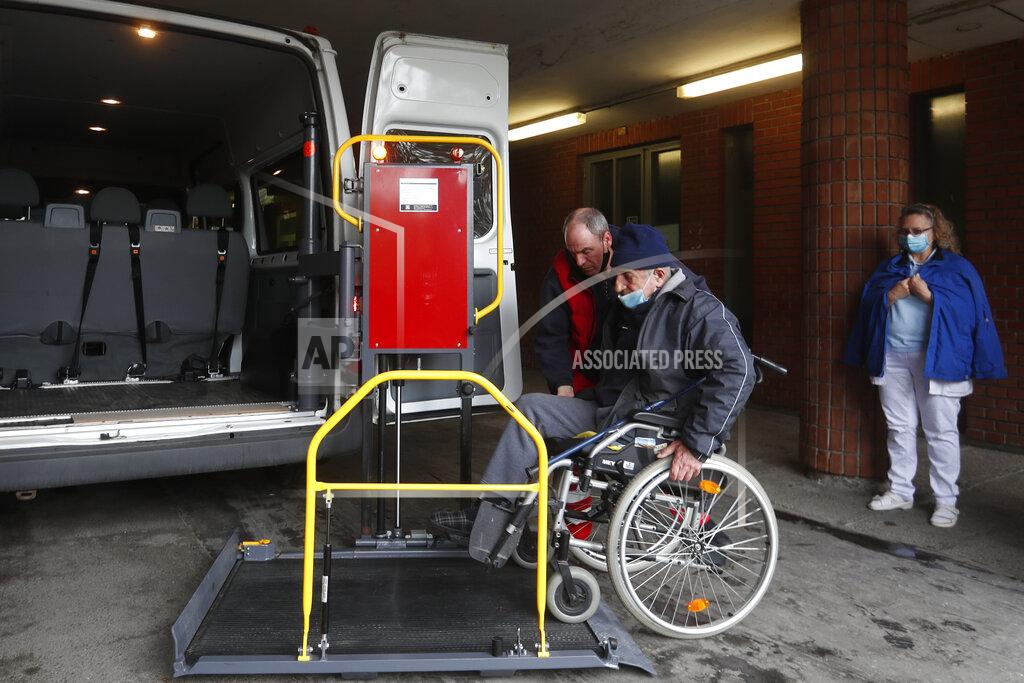 Laszlo Balogh An ambulance operator helps a a patient at the hospital for the homeless in Budapest, Hungary, Wednesday, April 14, 2021. A bitter conflict has emerged between Hungary’s right-wing government and the liberal leadership of the country's capital city over a hospital for the homeless that may soon have to close. The Budapest hospital provides medical and social services and shelter to more than 1,000 people annually. But the Hungarian government has ordered it to vacate the state-owned building it occupies. Budapest's mayor says the eviction will risk the lives of the hospital's homeless patients as Hungary struggles with a deadly COVID-19 surge.. (AP Photo/Laszlo Balogh)